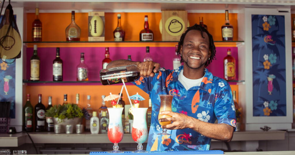 One of the friendly bartenders at Cabana Cafe on Grace Bay Beach. Image by Ileana of Attimi Photography.